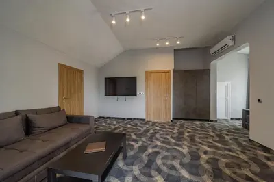 a living room with a couch and a flat screen tv at Forty One Luxury Spa in Belgrade