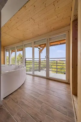 a large bathroom with a tub and large windows at Forty One Luxury Spa in Belgrade