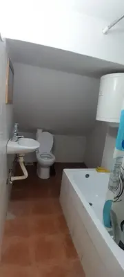 a bathroom with a sink and a toilet and a bath tub at Airport Guesthouse Rooms and Apartmants in Beograd