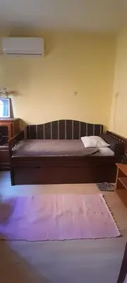 a bedroom with a bed with a purple rug at Airport Guesthouse Rooms and Apartmants in Beograd