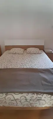 a bed with two pillows on top of it at Airport Guesthouse Rooms and Apartmants in Beograd