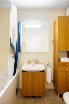 a bathroom with a sink and a mirror at Central Garden Apartment - Parking & Security in Belgrade