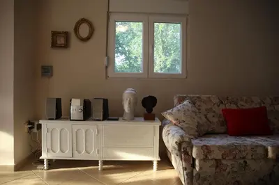 a living room with a couch and a window at ART HOUSE Kosmaj 1 in Sopot