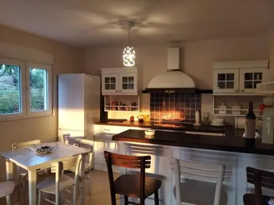 a kitchen with a table and chairs and a stove at ART HOUSE Kosmaj 1 in Sopot