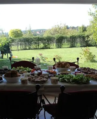 a table with food on it with a view of a field at ART HOUSE Kosmaj 2 in Sopot