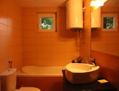 a bathroom with a tub and a sink and a toilet at ART HOUSE Kosmaj 2 in Sopot