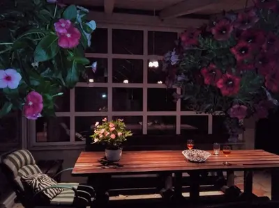 a wooden table with flowers in a room with a window at ART HOUSE Kosmaj 2 in Sopot