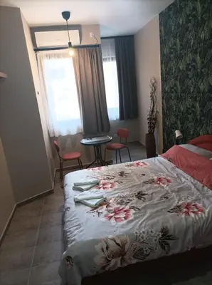 a bedroom with a bed with flowers on it at Katera S in Zemun