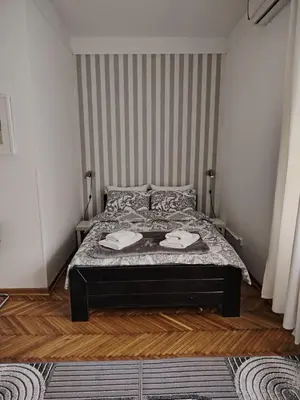 a bedroom with a bed with two towels on it at Apartment 20 in Belgrade