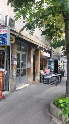 a store front of a building with a tree at Apartment 20 in Belgrade