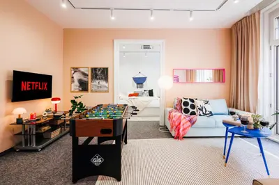 a living room with a couch and a table at Velvet Stay 120m2 with Foosball Old Town in Belgrade