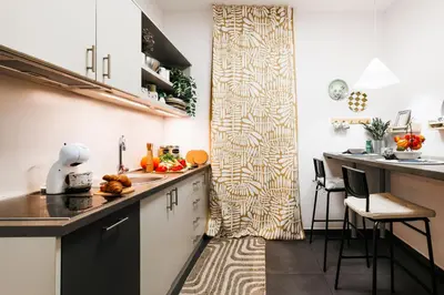 a small kitchen with a counter and a table at Velvet Stay 120m2 with Foosball Old Town in Belgrade