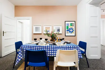 a dining room with a blue and white table and chairs at Velvet Stay 120m2 with Foosball Old Town in Belgrade