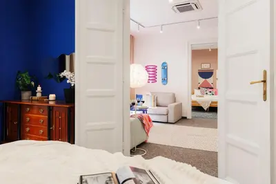 a bedroom with a door open to a living room at Velvet Stay 120m2 with Foosball Old Town in Belgrade