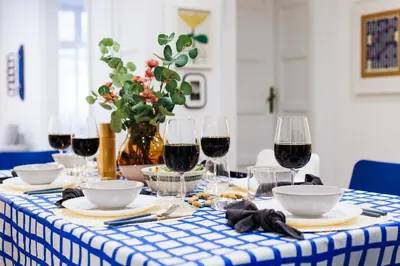a blue and white table with glasses of red wine at Velvet Stay 120m2 with Foosball Old Town in Belgrade