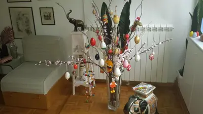 a vase with a christmas tree in a living room at ML Apartman in Belgrade