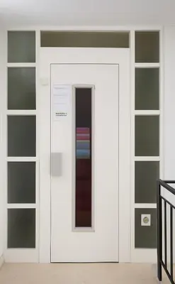 a white door with a window in a room at ML Apartman in Belgrade