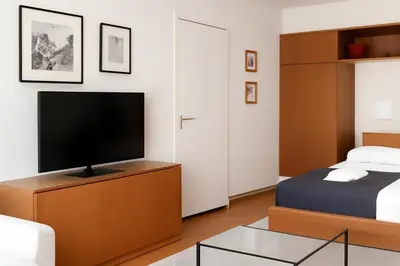 a bedroom with a bed and a flat screen tv at ML Apartman in Belgrade