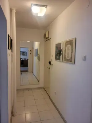 a hallway with a door and a tile floor at ML Apartman in Belgrade