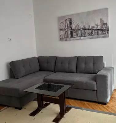 a living room with a couch and a coffee table at msapartman in Surčin