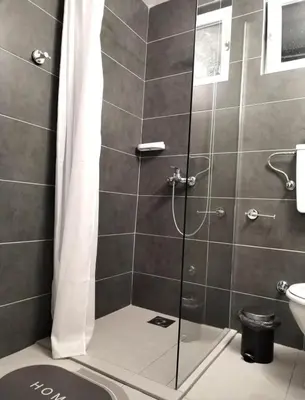 a shower with a glass door in a bathroom at msapartman in Surčin