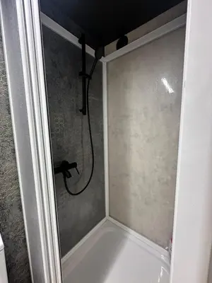 a shower in a bathroom with a shower at Unique River Houseboat Stay in Železnička Stanica Senjak