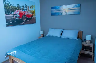 a bedroom with a bed and a red car on the wall at Unique River Houseboat Stay in Železnička Stanica Senjak