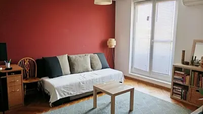 a living room with a couch and a table at Mansard Crimson Rhapsody in Belgrade
