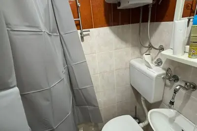 a small bathroom with a toilet and a sink at Point apartman 1 in Belgrade