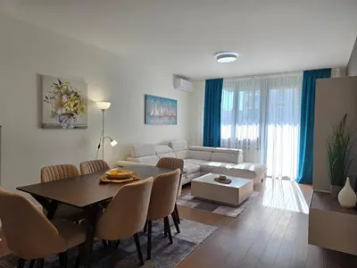 a living room with a table and a couch at BW Quartet 303 deluxe apartments in Belgrade
