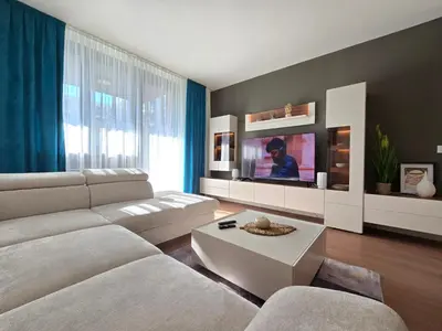 a living room with a couch and a tv at BW Quartet 303 deluxe apartments in Belgrade