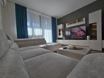 a living room with a couch and a tv at BW Quartet 303 deluxe apartments in Belgrade
