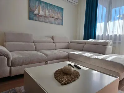a living room with a couch and a coffee table at BW Quartet 303 deluxe apartments in Belgrade