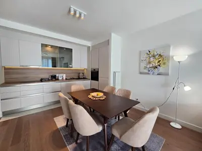 a kitchen and dining room with a table and chairs at BW Quartet 303 deluxe apartments in Belgrade