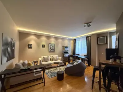 a living room with a couch and a table at Downtown family apartment in Belgrade
