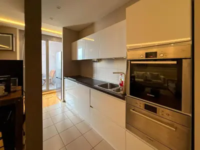 a kitchen with white cabinets and a stainless steel oven at Downtown family apartment in Belgrade
