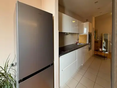 a kitchen with white cabinets and a stainless steel refrigerator at Downtown family apartment in Belgrade