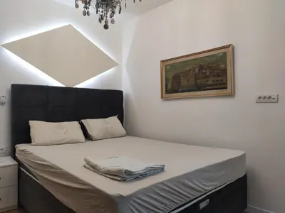 a bed with a black headboard in a bedroom at Nela Lux in Belgrade
