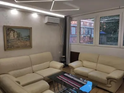 a living room with two couches and a table at Nela Lux in Belgrade
