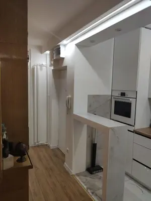 a kitchen with white cabinets and a counter top at Nela Lux in Belgrade