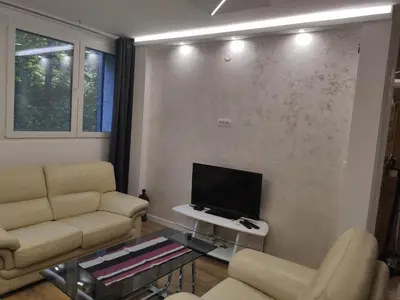 a living room with a couch and a tv at Nela Lux in Belgrade