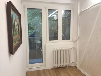 a white room with two windows and a radiator at Nela Lux in Belgrade
