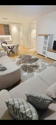 a living room with couches and tables and a table at BW QUARTET Apartman-whit free garage parking in Belgrade
