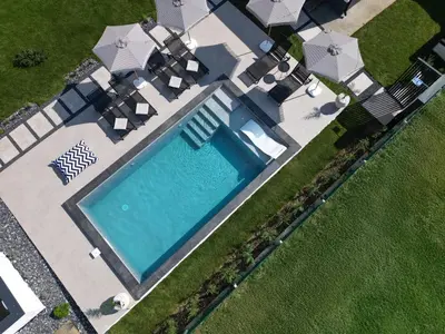 an overhead view of a swimming pool with umbrellas at Aeri Nature Concept in Baljevac