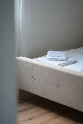 a white bed with a towel on top of it at Aeri Nature Concept in Baljevac