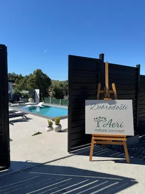 a sign for a resort with a swimming pool at Aeri Nature Concept in Baljevac