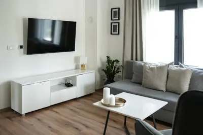 a living room with a couch and a tv on a wall at Aeri Nature Concept in Baljevac