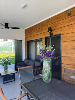 a vase of purple flowers sitting on a table at Aeri Nature Concept in Baljevac
