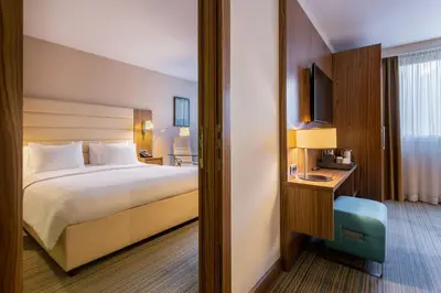 a hotel room with a bed and a television at Courtyard by Marriott Belgrade City Center in Belgrade