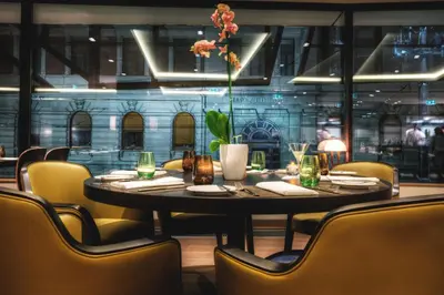 a dining room with a table and chairs at Courtyard by Marriott Belgrade City Center in Belgrade